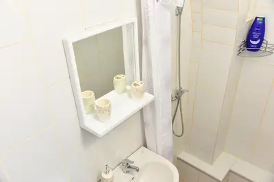 a bathroom with a sink and a mirror and a toilet at Apartmani Koko in Banja Luka