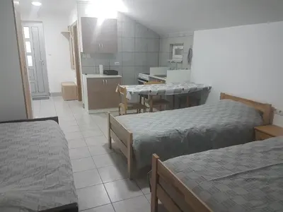 a small room with two beds and a kitchen at DASS apartmani in Banja Luka