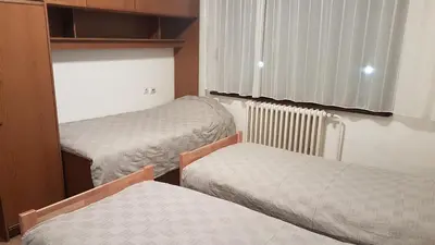 a small room with two beds and a window at DASS apartmani in Banja Luka