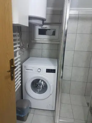 a washer and dryer in a small bathroom at DASS apartmani in Banja Luka