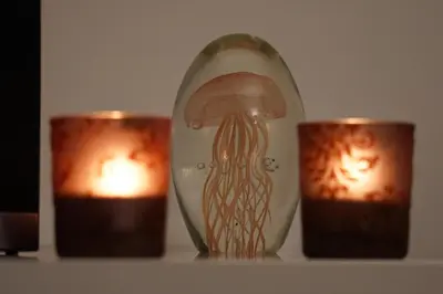 a vase with an octopus on it next to two candles at Jackey apartment in Banja Luka