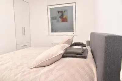 a bedroom with a bed with pillows on it at Jackey apartment in Banja Luka