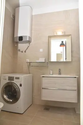 a bathroom with a washing machine and a sink at Jackey apartment in Banja Luka