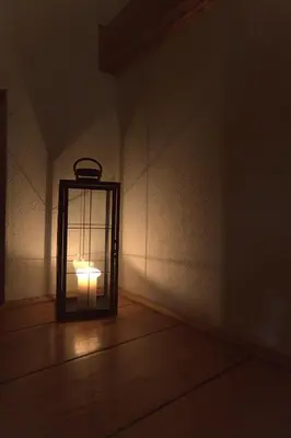 a lantern in the corner of a room at Kiwi Chalet in Kupres