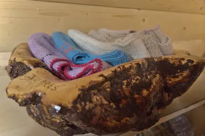a group of shoes and socks sitting on a shelf at Kiwi Chalet in Kupres