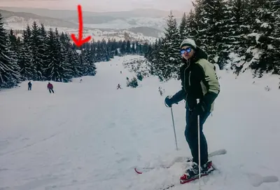 a person on skis in the snow with a red arrow at Vikendica Eden in Vlasic