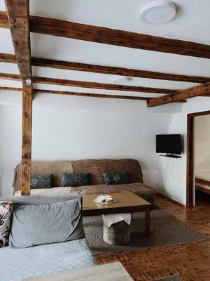 a living room with a couch and a table at Vikendica Eden in Vlasic