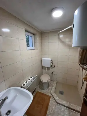 a bathroom with a toilet and a sink and a tub at Vikendica Eden in Vlasic