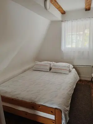 a bed with two pillows on it in a room at Vikendica Eden in Vlasic