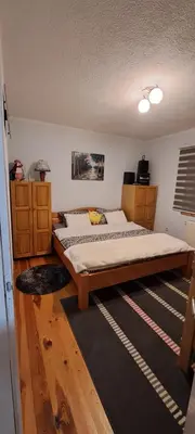 a bedroom with a large bed in a room at Apartman Jonjić in Kupres