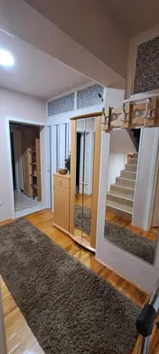 a room with a staircase and a living room at Apartman Jonjić in Kupres