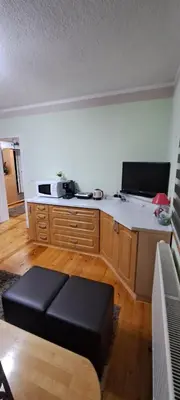 a living room with a kitchen with a counter top at Apartman Jonjić in Kupres