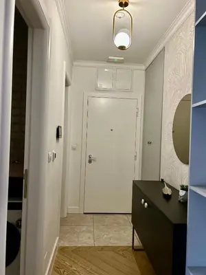 a bathroom with a white door and a black cabinet at Apartman Venecija Banja Luka in Banja Luka
