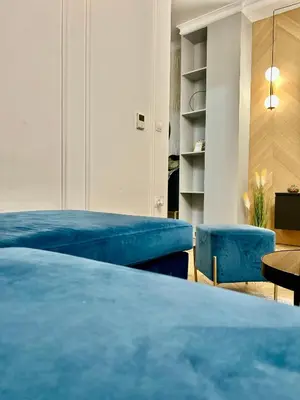 a bedroom with a blue bed and blue chairs at Apartman Venecija Banja Luka in Banja Luka