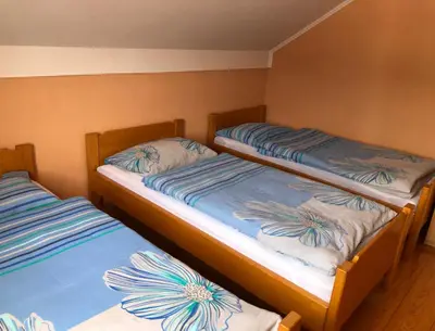 two twin beds in a room with at Apartmani Turalija in Kupres