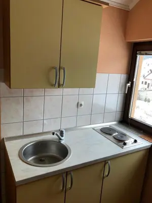 a kitchen with a sink and a counter at Apartmani Turalija in Kupres