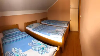two twin beds in a small room with at Apartmani Turalija in Kupres