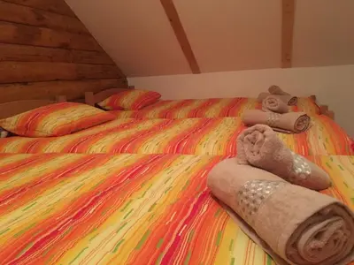 a bed with two teddy bears and towels on it at GOLD RIVER in Krupa na Vrbasu