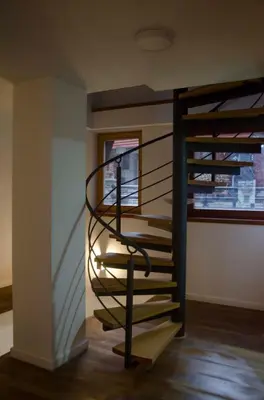a spiral staircase in a room with a window at KUĆA NENO in Vlasic