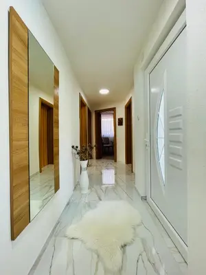 a hallway with a white rug on the floor at Crystal Račić in Bihać