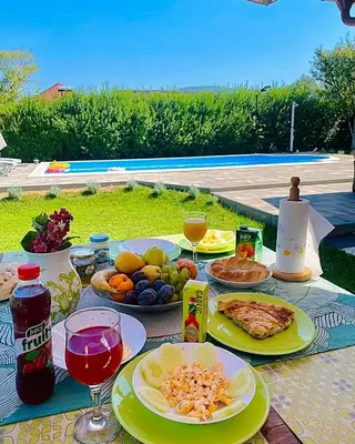 a table with plates of food and drinks on it at Crystal Račić in Bihać