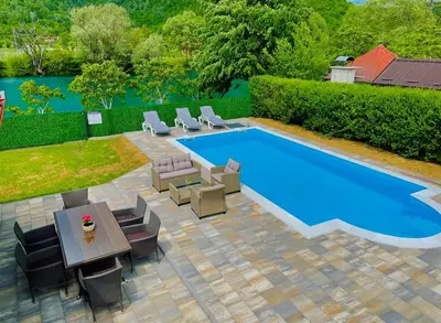 an overhead view of a pool with chairs and a table at Crystal Račić in Bihać