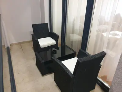 a room with two chairs and a mirror at City Center Apartment in Banja Luka