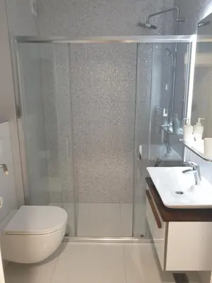 a bathroom with a shower and a toilet and a sink at Apartman Viktoria in Tuzla