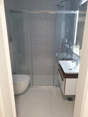 a bathroom with a shower and a toilet and a sink at Apartman Viktoria in Tuzla