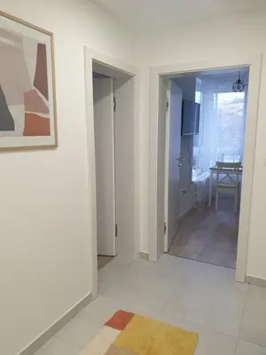 a room with a hallway with a table and a picture at Apartman Viktoria in Tuzla