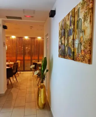 a hallway with a painting of wine bottles on the wall at Hotel Tanja in Banja Luka