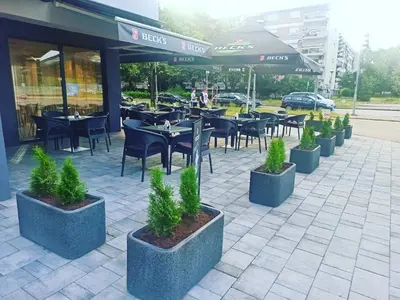 a row of tables and chairs in front of a restaurant at Hotel Tanja in Banja Luka