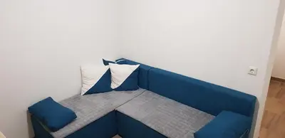 a blue bench with two pillows in a room at Apartman za dvoje in Vlasic