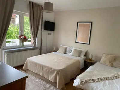 a bedroom with two beds and a window at Hostel Mornar in Velika Kladuša
