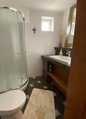 a bathroom with a shower and a toilet and a sink at Hostel Mornar in Velika Kladuša