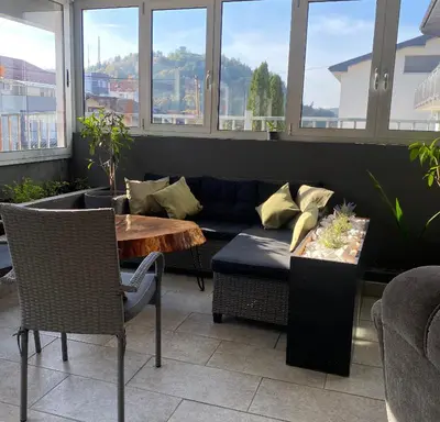 a living room with a couch and a table at Hostel Mornar in Velika Kladuša
