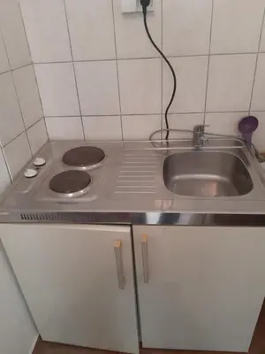a kitchen with a sink and a stove at SubotićSmještaj in Kulaši