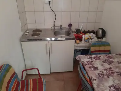 a small kitchen with a sink and a counter at SubotićSmještaj in Kulaši