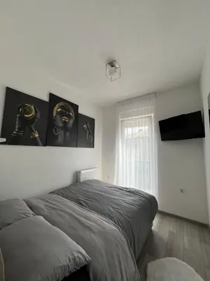a bedroom with a bed and a television in it at Apartment Nostra Aula in Travnik