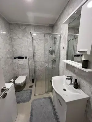 a bathroom with a shower and a sink and a toilet at Apartment Nostra Aula in Travnik