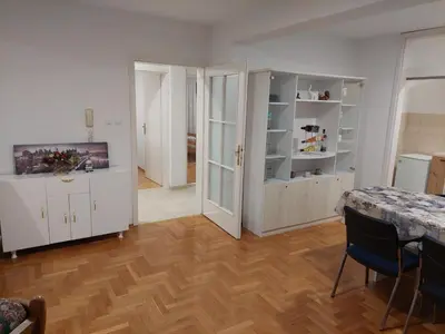 a living room with white cabinets and a wooden floor at Aleksandar in Banja Luka