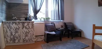 a kitchen with a table and chairs and a window at Studio Apartman SAJRA in Kulen Vakuf