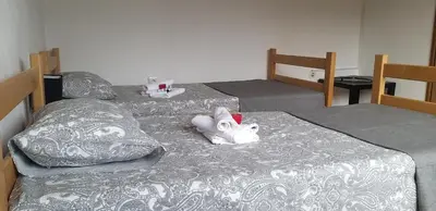 two beds in a room with two beds sidx sidx sidx sidx at Studio Apartman SAJRA in Kulen Vakuf