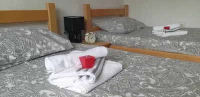 a hotel room with two beds and a red cup at Studio Apartman SAJRA in Kulen Vakuf