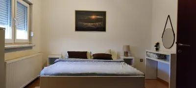 a bedroom with a bed and a picture on the wall at Penthouse Park in Banja Luka