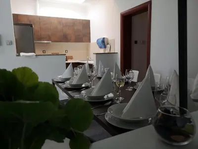 a long table with glasses and plates on it at Penthouse Park in Banja Luka
