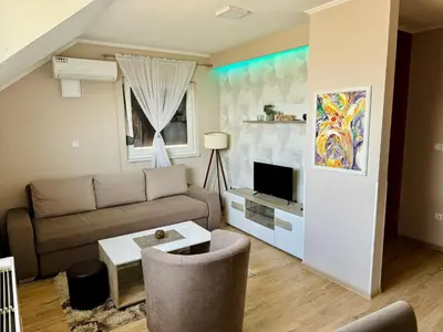a living room with a couch and a tv at Gradiska na Savi apartmani i sobe in Bosanska Gradiška