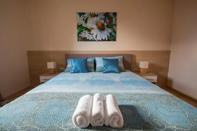 a bedroom with a bed with two towels on it at Gradiska na Savi apartmani i sobe in Bosanska Gradiška