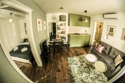 a living room with a couch and a bed at Polar Apartments Banja Luka LPIJ in Banja Luka