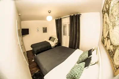 a small room with two beds and a tv at Polar Apartments Banja Luka LPIJ in Banja Luka